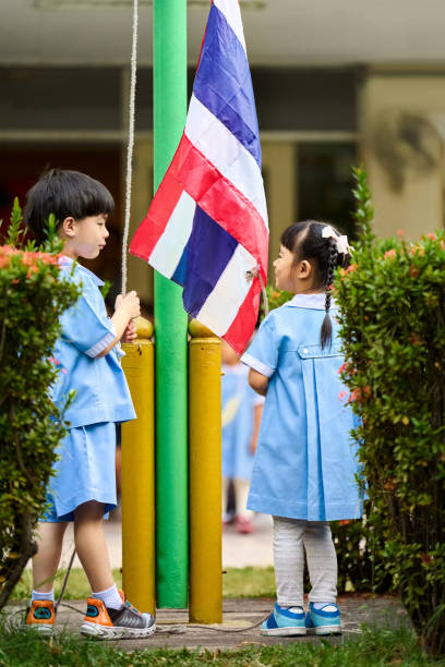 istock Kindergarten students participating in flag raising ceremony outdoors 2157552746