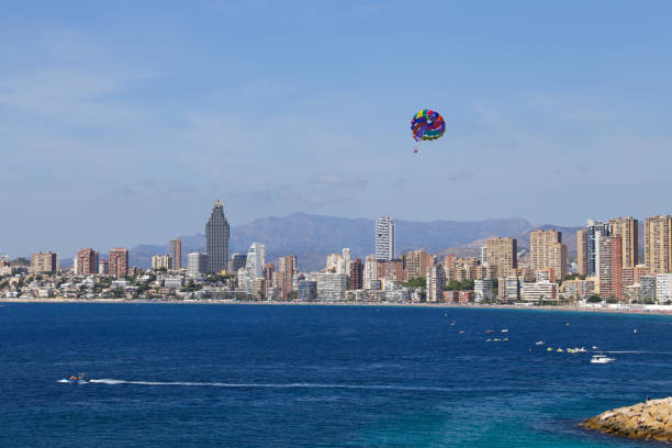 istock People parascending on Benidorm beach under blue sky 2157552823