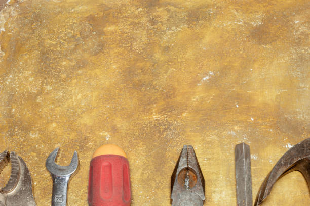 Old working tools on a worn background. Concept of labor day. Image with copy space.
