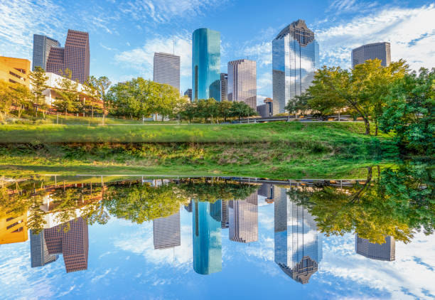 skyline of houston, texas in morning light seen from buffalo bayou park and reflection in river - houston-texas bildbanksfoton och bilder