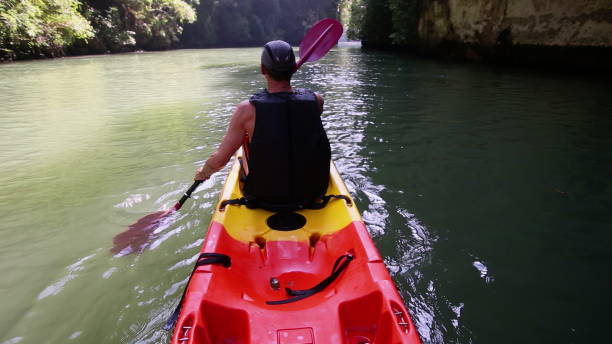 istock Tourist smoothly navigates kayak using paddle in canyon 2157561237