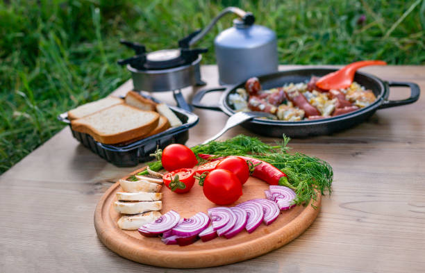 Cooking food in a frying pan while camping.