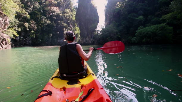 istock Man uses paddle smoothly navigating kayak in calm river 2157561368