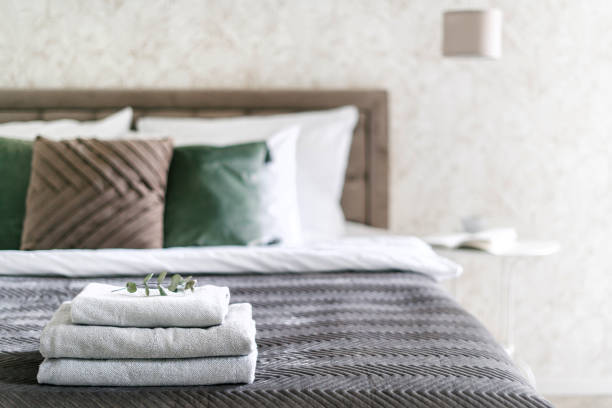 istock Clean towels on double bed in cozy home with guest bedroom 2157561518