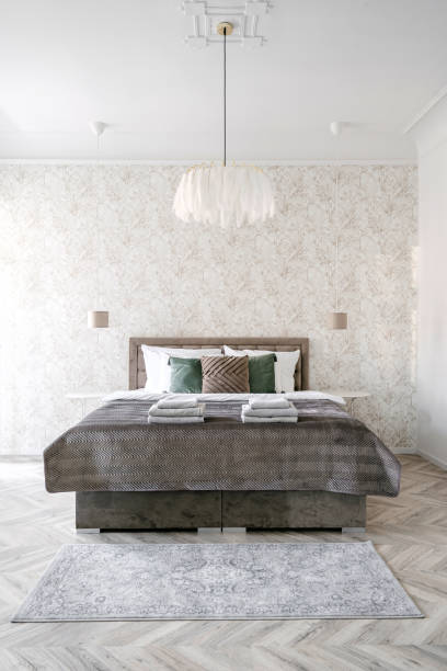istock Classic style hotel bedroom with comfortable double bed and neatly folded towels 2157561522