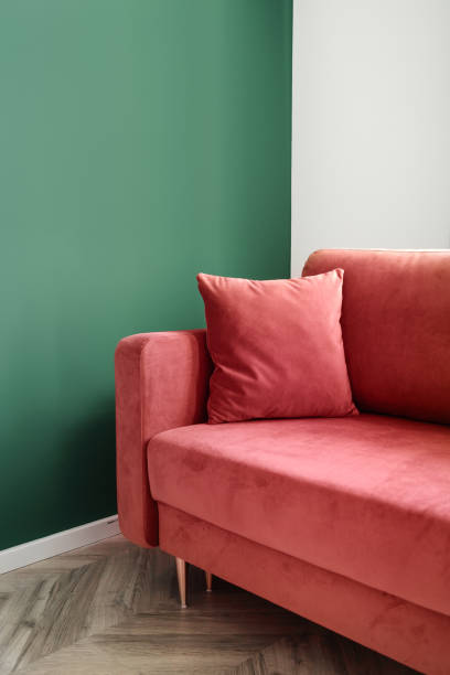 istock Comfortable sofa with soft decorative pillow in living room with green wall 2157561532