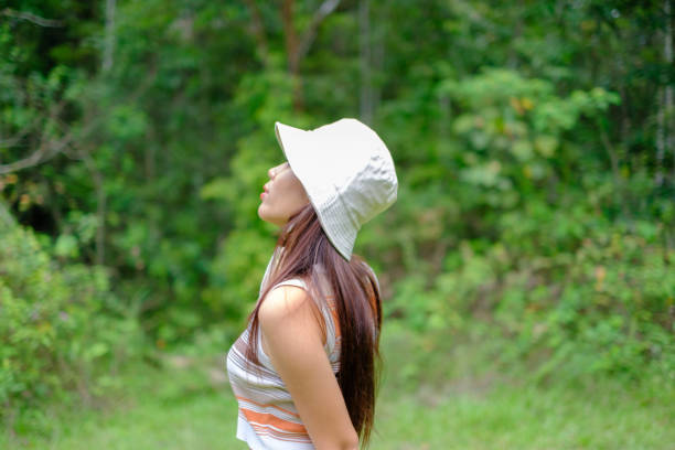 Beautiful Asian girl taking a walk in the forest