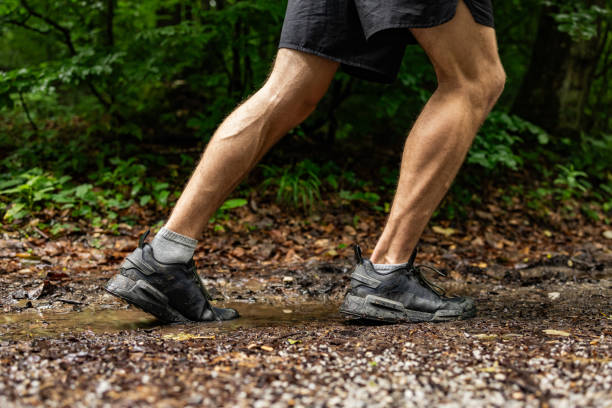 istock Off road male trail runner running   into the muddy puddle 2157562311