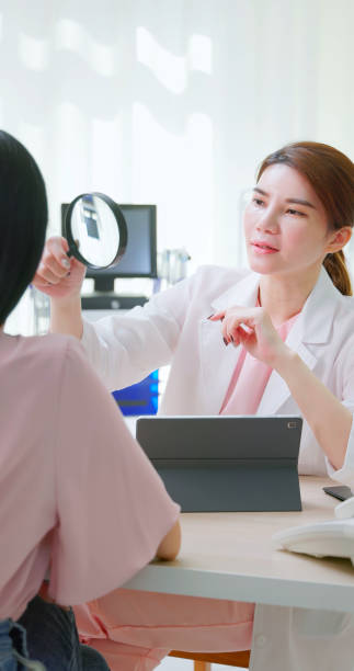 istock female doctor use magnify diagnose 2157563559