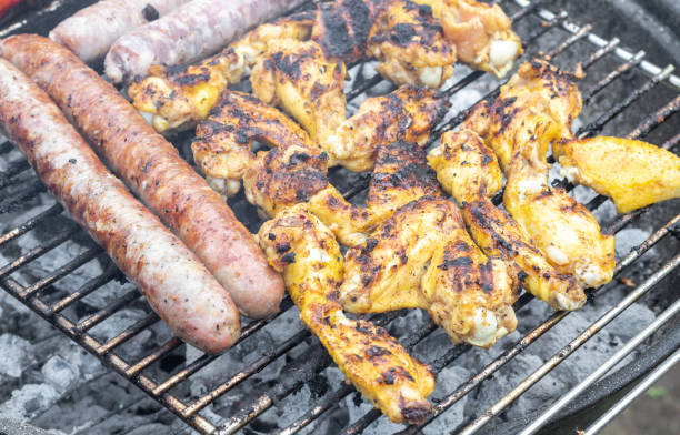 istock Fried sausages and grilled chicken wings. 2157564282