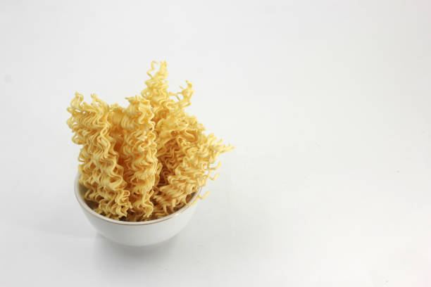 dry noodles, egg noodles, isolated on a white background