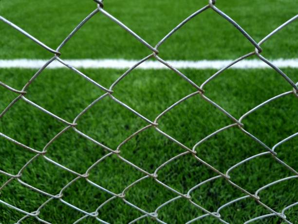 istock Metal mesh and football turf 2157566001