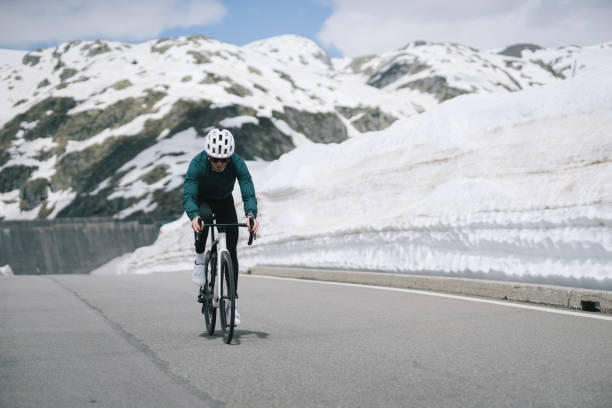 istock Road biker rides to high mountain pass, Gotthard Pass 2157566214