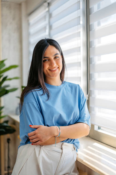 istock Young Woman Standing By The Window At Home 2157566279