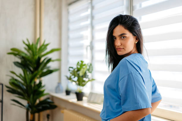 Free Stock Photo of Woman in Blue Shirt Standing in Front of Window ...