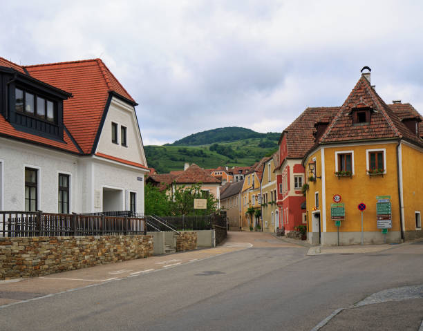 Weibenkirch, Lower Austria, 25-05-24. Pretty town of Weibenkirchen with colourful houses and toourist directional signs mounted on a house, a popular stop off for river cruise passengers