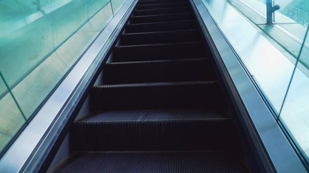 istock Ascending electric escalator or moving staircase. Toned image 2157572101