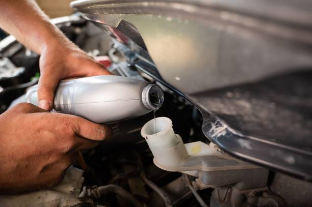 istock An auto mechanic pours brake fluid into the car 2157573487