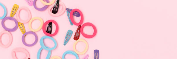 istock Banner with multicolored hair scrunchies and clips. 2157575000