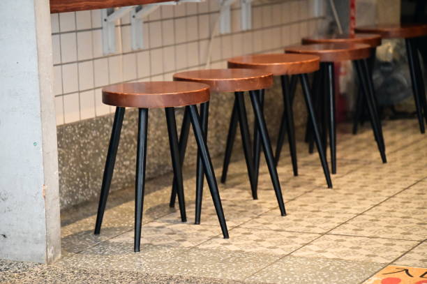 istock Industrial-Style Restaurant: Wood Stools, Tile Floors, and White Walls 2157576065