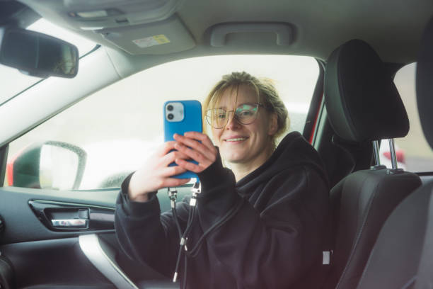 istock Happy Traveller Using Smartphone Inside of Car During Road Trip 2157577035