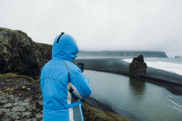 istock Traveller Admiring Dramatic Black Sand Beach From Above 2157577087