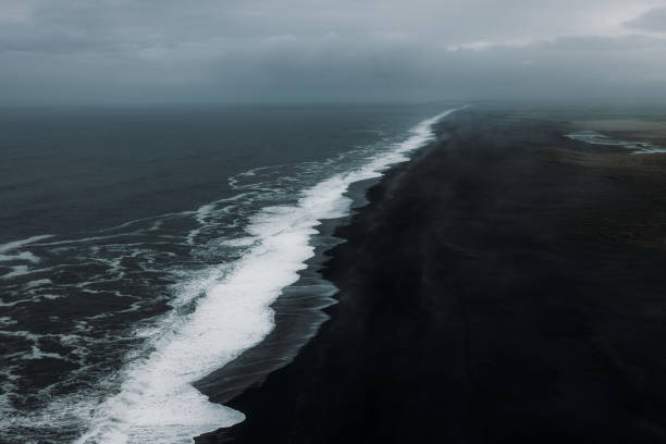 istock Aerial View of Mystical Endless Panoramic Black Sand Beach 2157577194
