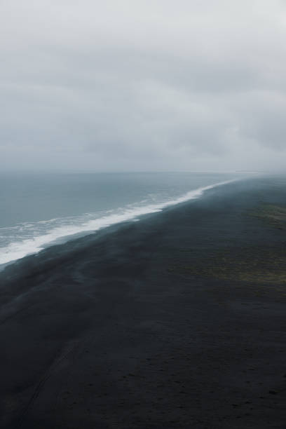 istock Aerial View of Mystical Endless Panoramic Black Sand Beach 2157577216