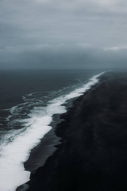 istock Aerial View of Mystical Endless Panoramic Black Sand Beach 2157577229