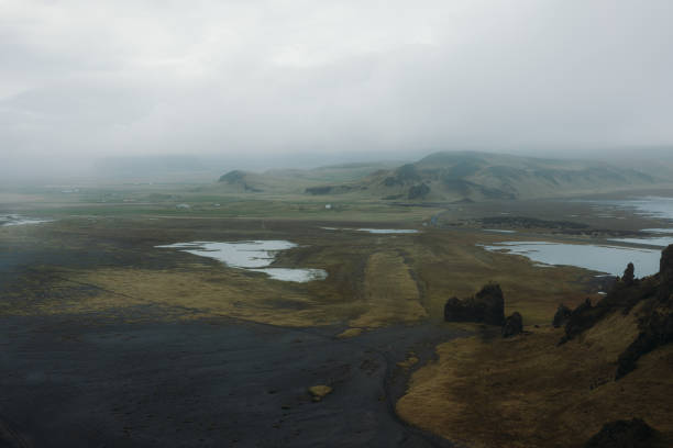 Dramatic volcanic landscape road and green hills with cliffs  in South Iceland