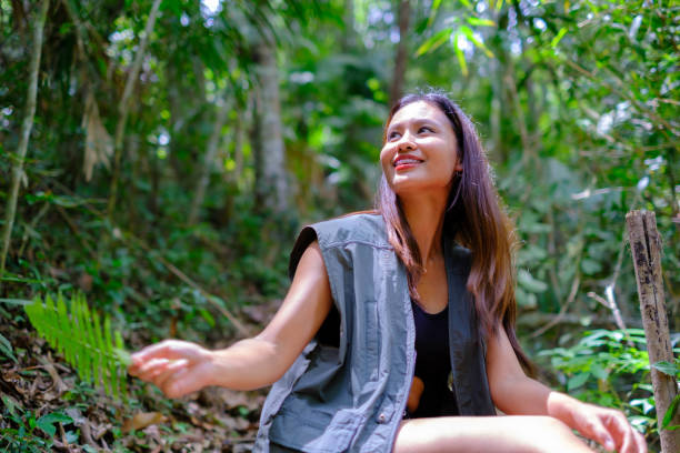 istock Asian woman walks in to explore the forest 2157577332