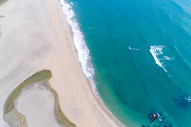 istock Aerial view of sandy beach and ocean with waves 2157578403