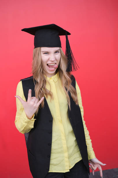 istock Young beautiful blond female in graduation cap with emotional expression 2157579042