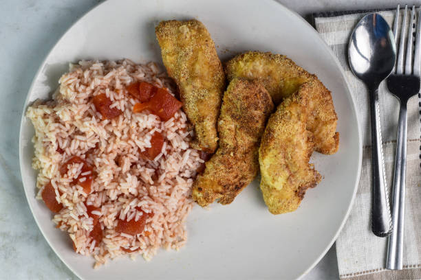 istock chicken  fingers served   with  rice and tomatos 2157580838