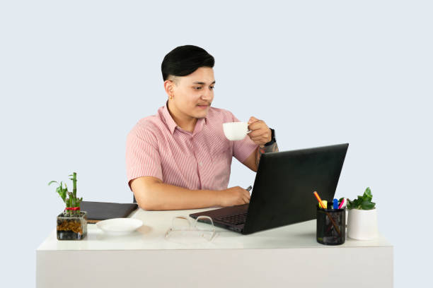 istock Front Desk Male Receptionist with Mobile Device Laptop and Notepad 2157584492