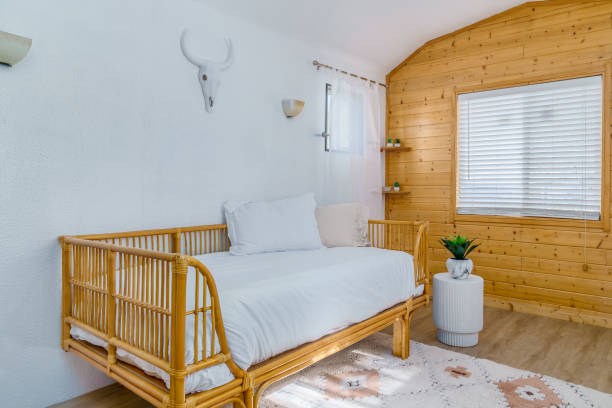 istock Rattan daybed boho cabin bungalow knotty pine paneling 2157592507