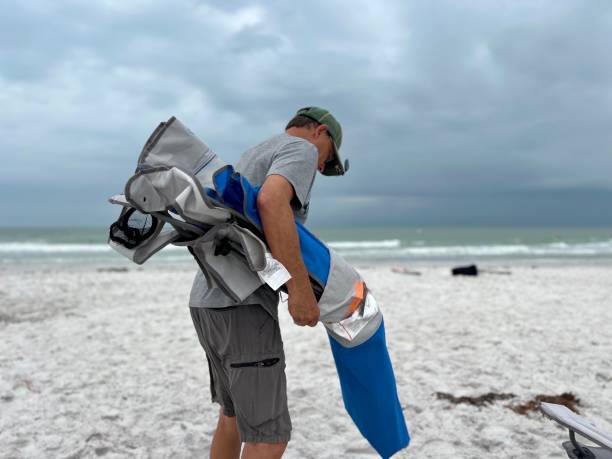 istock Storm coming with senior man packing up on Florida beach 2157597595