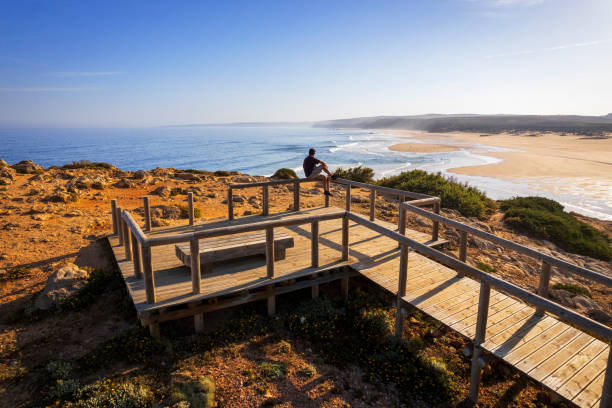 istock Tourist on walkway admiring ocean, Algarve 2157599047