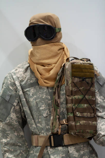 istock Mannequin in desert camouflage gear on gray background 2157600092