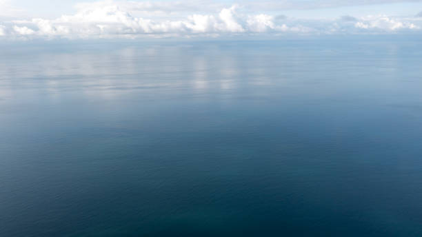 Aerial view of endless sea and cloudy sky.