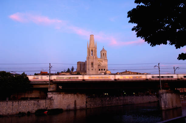 the train passing through the Onyar river in Girona, Catalonia, Spain