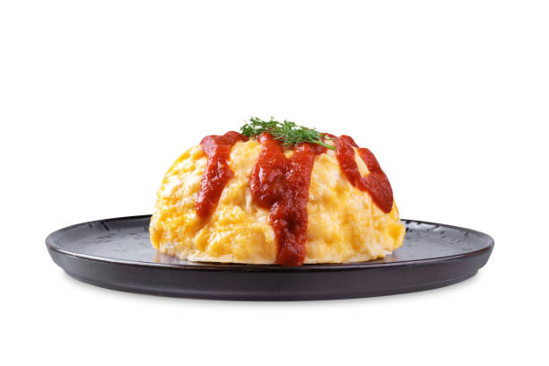 Omurice with ketchup sauce in a plate on a white isolated background. toning