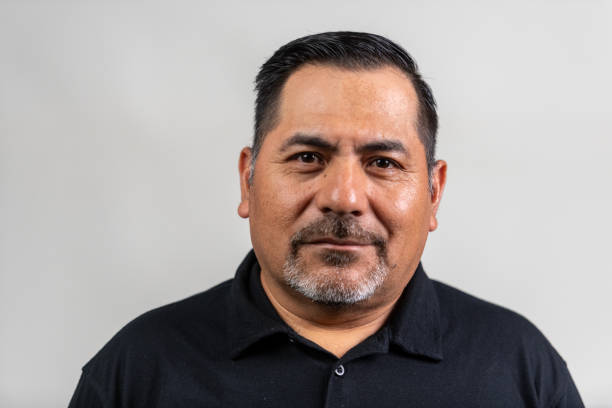 istock Smiling hispanic mature man posing looking at the camera isolated on white background 2157615369