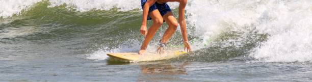 istock Young man surfing in bright sunshine 2157616422