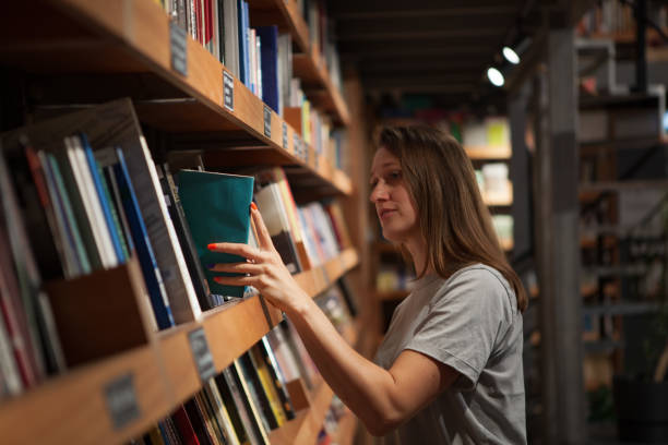 istock Woman Browsing Bookshelf in a Bookstore 2157616524