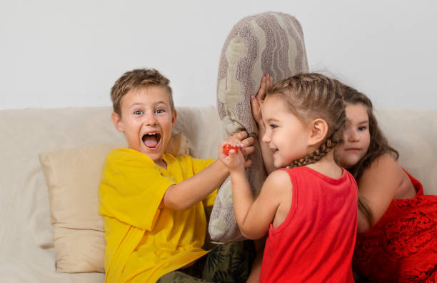 Siblings playing hand game at home