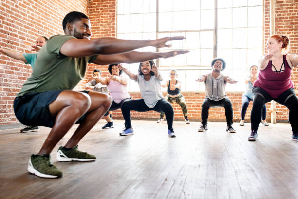 istock People doing squats in fitness class 2157637301