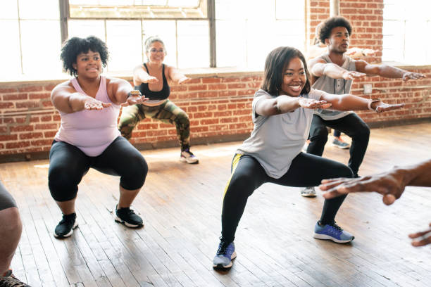 istock People doing squats in fitness class 2157637309