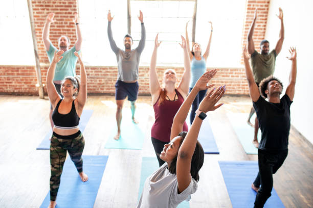 istock Trainer and her students in a Urdhva Hastasana pose 2157637397