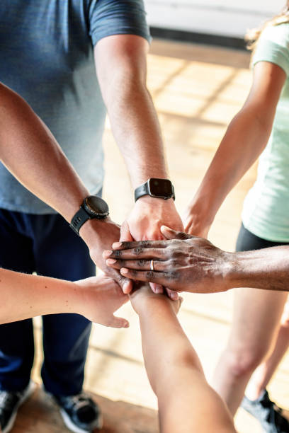 istock Sporty people joining hands together 2157637443
